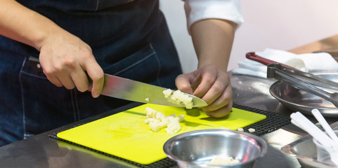 Chef cuts the vegetables cooking in a kitchen, hands slicing vegetables, preparing vegetables