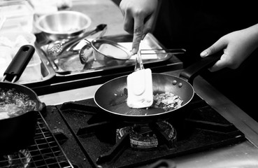 Fototapeta na wymiar Chef cooking in a kitchen, chef at work, Black & White.