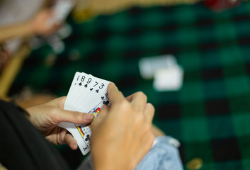 People  playing card and paying coin 
