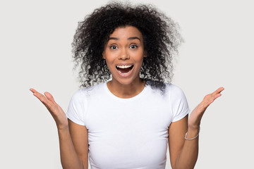 Excited happy African American woman with open mouth celebrating success