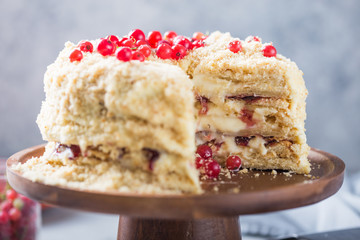 Birthday  creamy layer cake napoleon or chopped cake.  Confectioner decorated with berries on a baking sheet, delicious sweetness. The concept of homemade pastry, cooking pie.