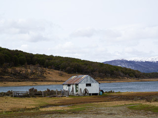 Fototapeta na wymiar small wooden house on the shore of Beagle Channel