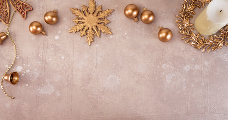 Bronze Christmas balls, snowflake, wreath and white candle on a vnazhny background with blots. New Year mood