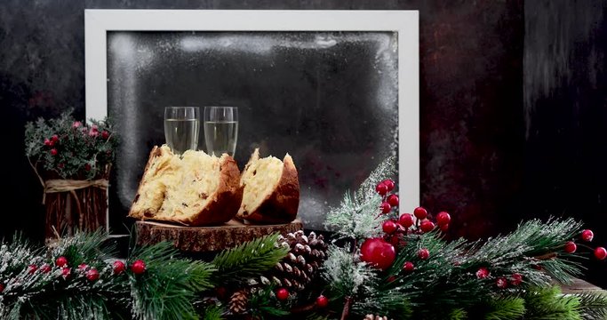 Slices of panettone and champagne flutes on Christmas table