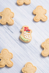Obraz na płótnie Canvas confectionery, on a light gray background, cookies in the form of a snowman and Santa Claus