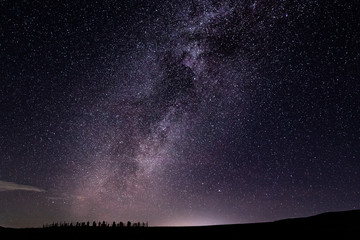 Milky Way in the starry sky above the old cemetery