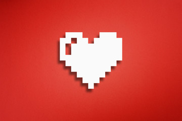 Pixel heart shape made from cut paper on red background