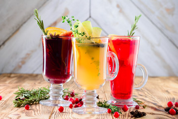 three glasses mulled wine on a rustic wooden table copy space background