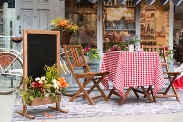 Fototapeta na wymiar table and chairs in front of a cafe in Italy or France. Provence style