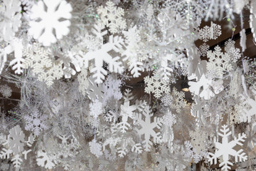 Variety of hanging white artificial snowflakes of different shapes and sizes for Christmas and New Year decoration