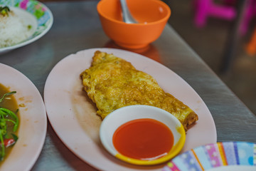  Fried omelette egg with tomato sauce is a very popular food in Thailand.