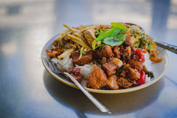 Spicy Southern Thai style ,a stir chicken bamboo shoot and cha Om Egg with shrimp paste sauce over stream rice.