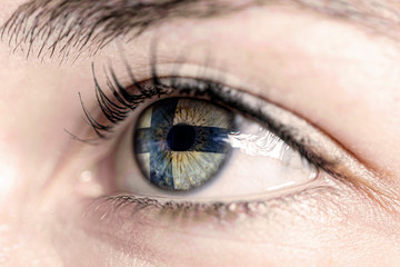 Fototapeta na wymiar Flag of finland reflects in woman green eye - close-up view - election, sport, hope, young, generation 