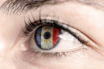 Flag of france reflects in woman green eye - close-up view - election, sport, hope, young,...