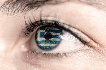 Obraz premium Flag of greece reflects in woman green eye - close-up view - election, sport, hope, young, generation 