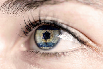 Flag of israel reflects in woman green eye - close-up view - election, sport, hope, young,...