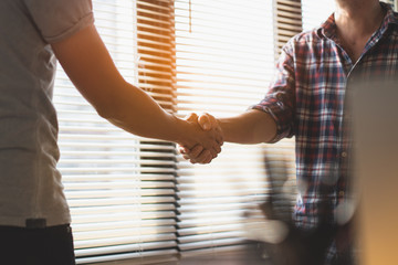 Successful deal, male architect shaking hands with client.