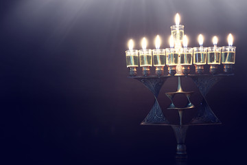 Religion image of jewish holiday Hanukkah background with bronze david star menorah (traditional...