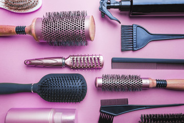 Various hair dresser and cut tools on pink background with copy space