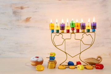 Religion image of jewish holiday Hanukkah background with menorah (traditional candelabra) and colorful oil candles