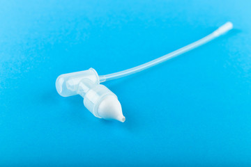 device for cleaning the nasal cavity, tube. On a blue background. children's nasal tube.