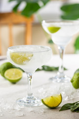 Refreshing Homemade Classic Alcoholic Margarita Cocktail with Lime and Salt on light background