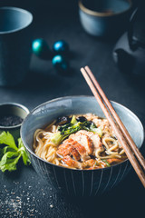 japanese soup with fried eel Yanagawa Nabe in a bowl on dark background