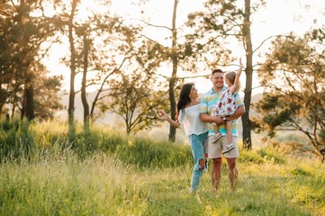 Fototapeta premium happy family concept - father, mother and child daughter having fun and playing in nature.