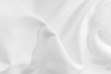 Obraz premium Abstract white fabric texture background. Cloth soft wave. Creases of satin, silk, and cotton.