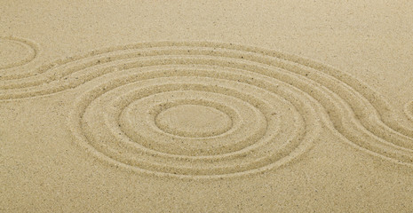 Fototapeta na wymiar Zen drawing in the sand. The concept of harmony, balance and meditation, spa, relaxation.