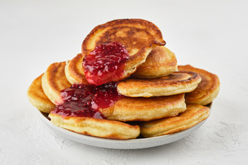 Delicious pancakes with  raspberry jam on white background closeup