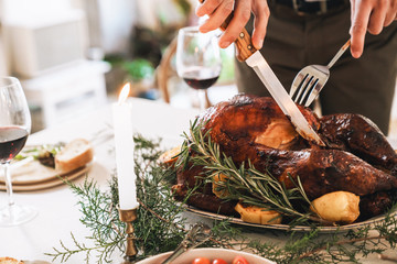 Close up of a man cutting roasted turkey