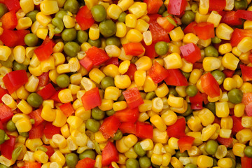 a mixture of vegetables paprika, corn, peas. top view macro shot	
