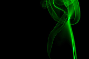 GREEN SMOKE AGAINST BLACK BACKGROUND