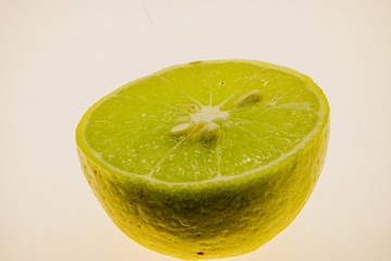 macro shot of ripe lime sliced to half isolated on white background
