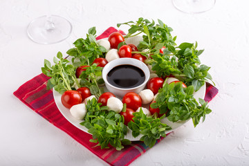 Caprese skewers with balsamic glaze, caprese salad Christmas wreath. Delicious appetizer, finger food.