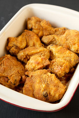 Delicious homemade oven baked fried chicken in a dish, side view. Close-up.