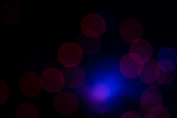 Colorful blue and pink lens flares with beautiful bokeh on black background