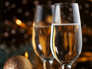 Two glasses of champagne on a gold background. Christmas card