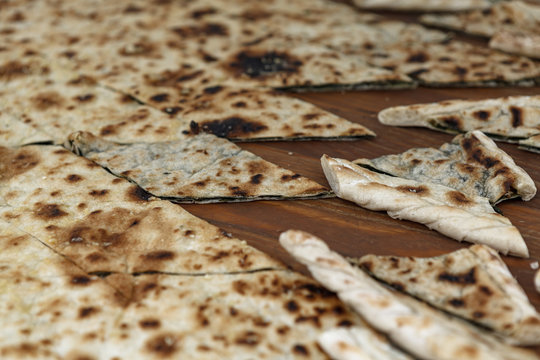 Close up of Soparnik. Simple pie filled with vegetables. Pie is made with chard and red onions, spread between two sheets of thinly rolled dough. 