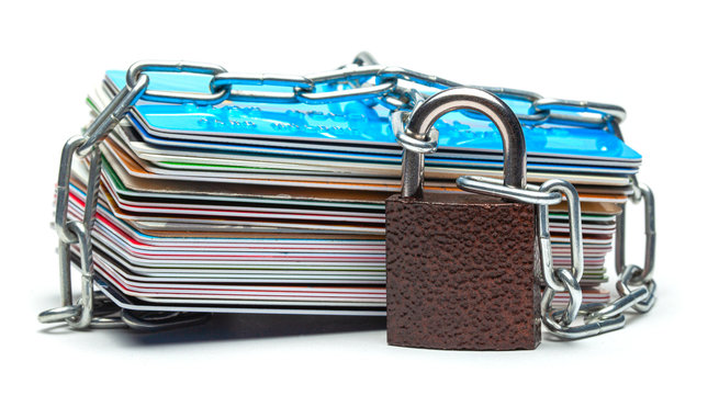 Stack of credit cards and a padlock with chain isolated on a white background. Closed access to credit cards, blocked, lock