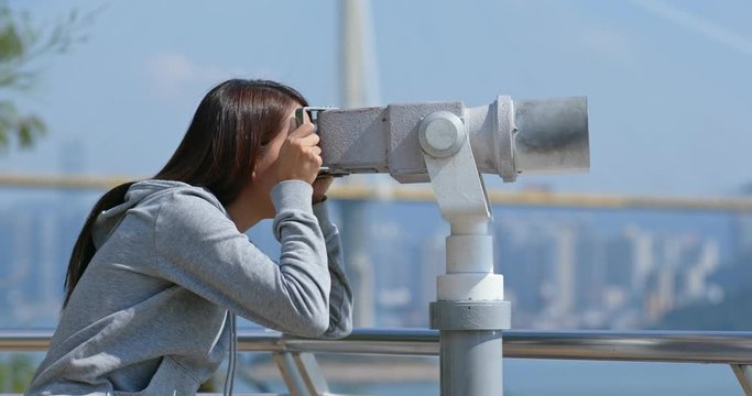 Tourist look at the binocular for seeing the view in Hong Kong