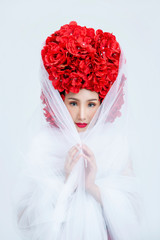 Beautiful portrait Asian woman looking wearing red flower head with soft white fabric dress on isolated.