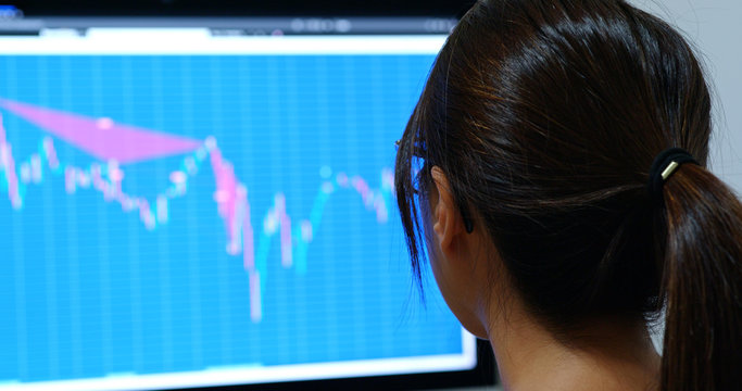 Woman study on stock market data