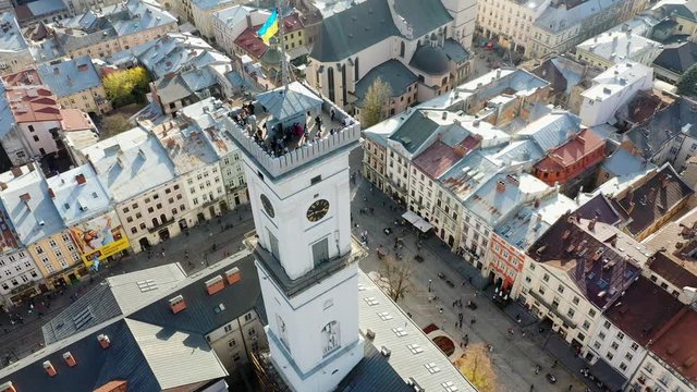 Aerial drone video of Lviv Old City center - roofs and streets, city hall Ratusha