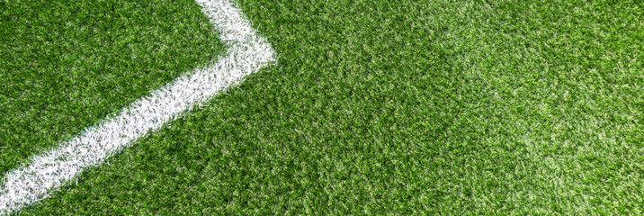 Soccer football sport background. Green synthetic artificial grass soccer sports field with white corner stripe line