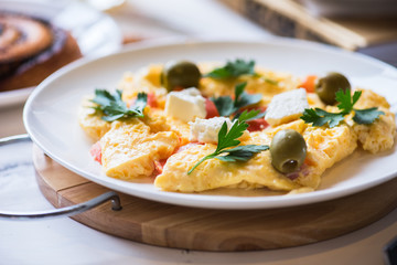 Fluffy fresh omelette with herbs olives and cheese.