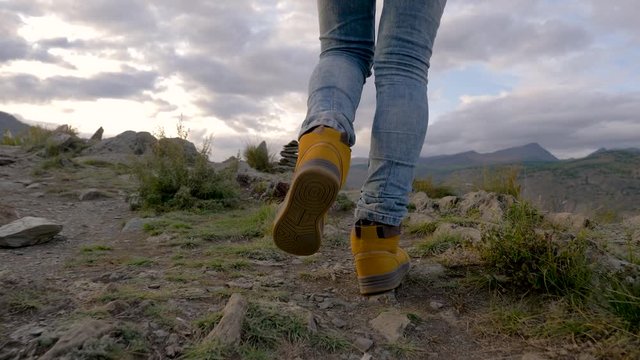 Successful 30s Man Walks Hike Mountains to Top. Freedom Guy Tourist in Boots Going Along Stone Road a Beautiful Landscape. Travel Concept Active People on Way to Victory Move Forward Close Up Land 4K