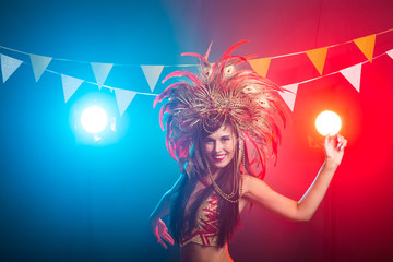 Carnival, dancer and holiday concept - Beauty brunette woman in cabaret suit and headdress with...