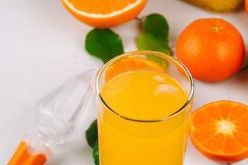 Glass of orange juice and orange slices